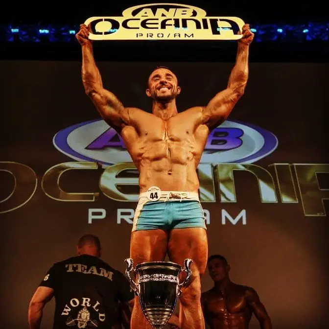 Nikolai celebrating his ANB bodybuilding Pro Card victory on stage